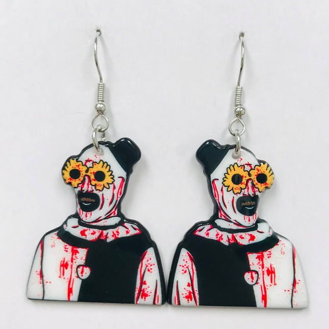 Art the Clown earrings made of acrylic, featuring a horror design with blood splatters and flowered glasses.